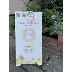 可愛らしいイラストが目を引く。ひまわりが映える清潔感のある看板を製作いたしました。