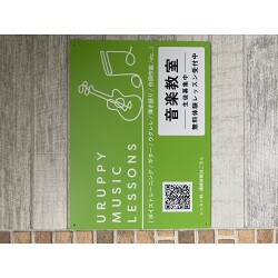 発色の良い黄緑色にピアノとギターのラインアートが目を引く音楽教室の店舗看板を製作いたしました。